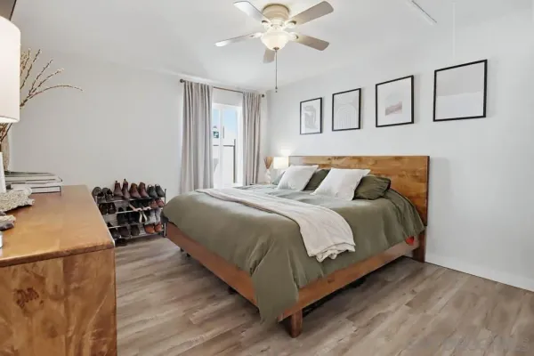 a bedroom with bed and a chandelier