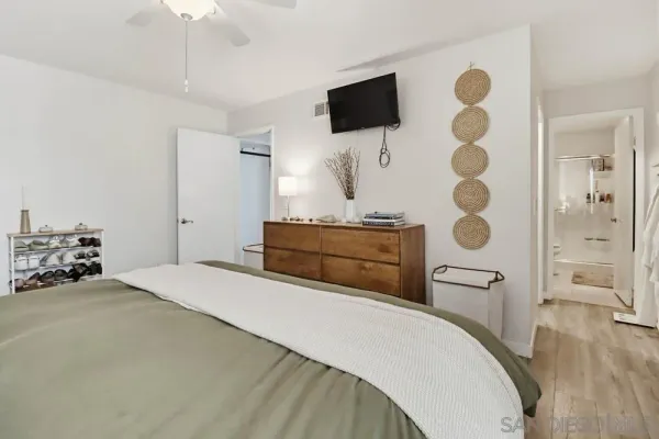 a bedroom with a bed and a flat screen tv