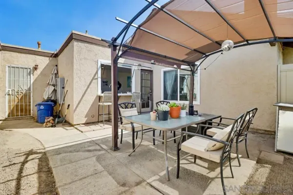 a view of a patio with table and chairs