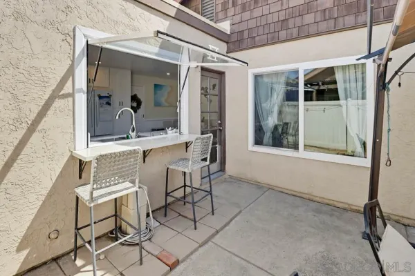 a view of a patio with table and chairs and potted plants