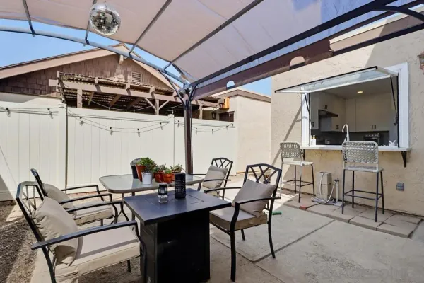 a view of a dining room with furniture and chandelier
