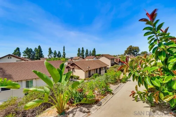 an aerial view of a house with a yard and lake view