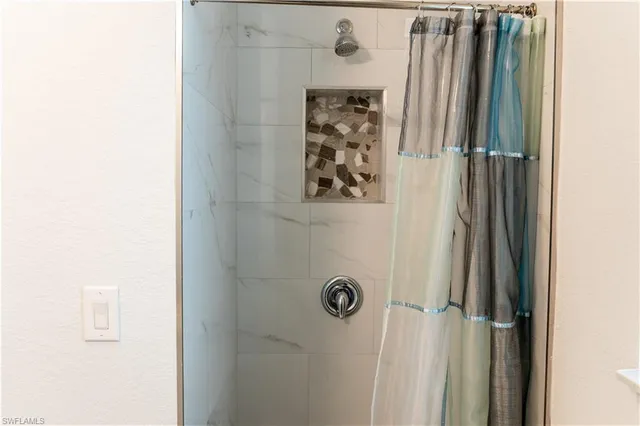 a bathroom with a shower and a door