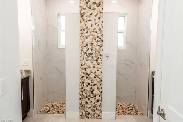 a bathroom with a shower and a window