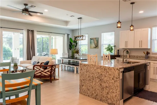 a living room with furniture a table and chairs