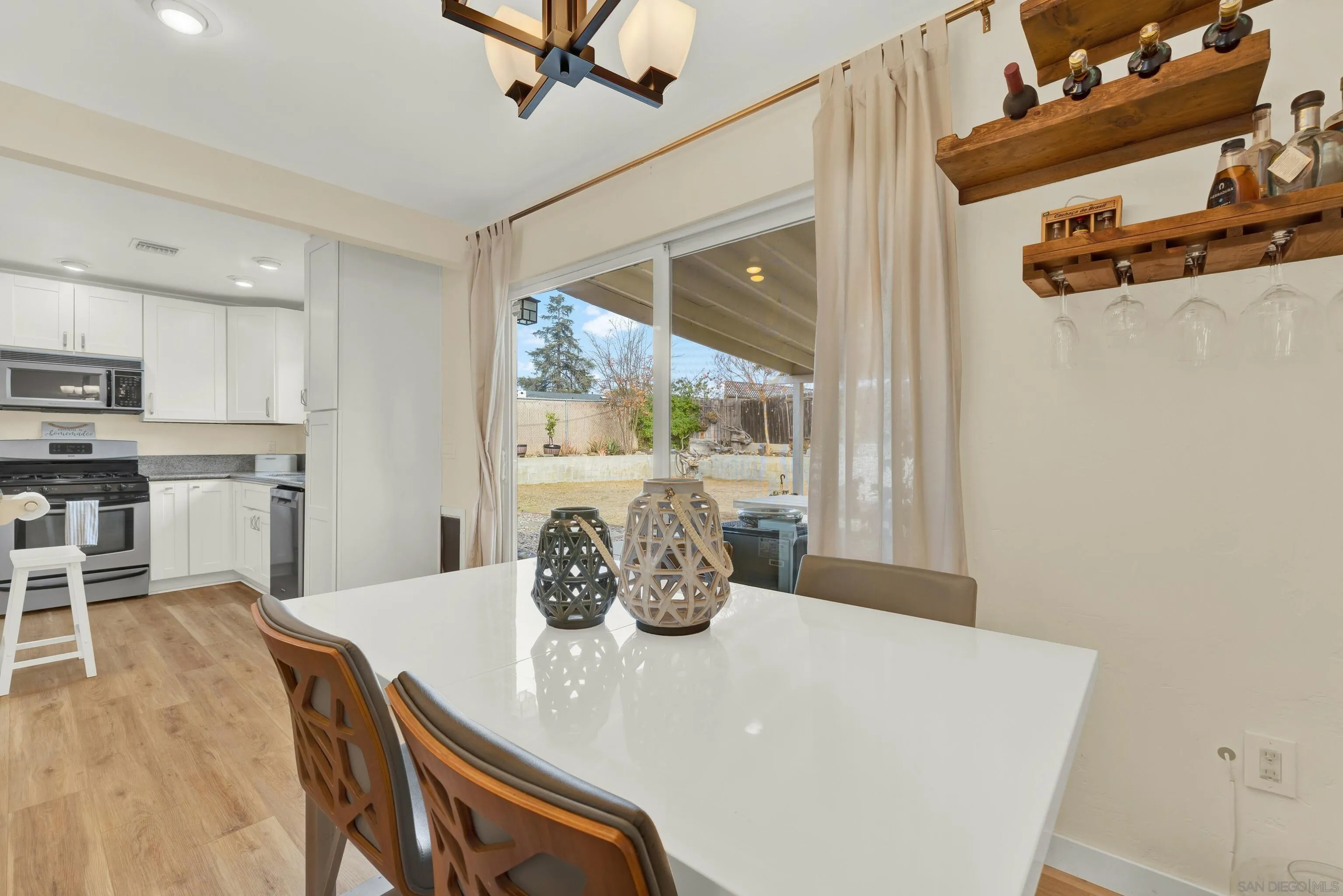 9515 Domer Road Santee, CA 92071 - Photo 16 of 45 a kitchen with stainless steel appliances granite countertop a sink a stove and a refrigerator with wooden floor