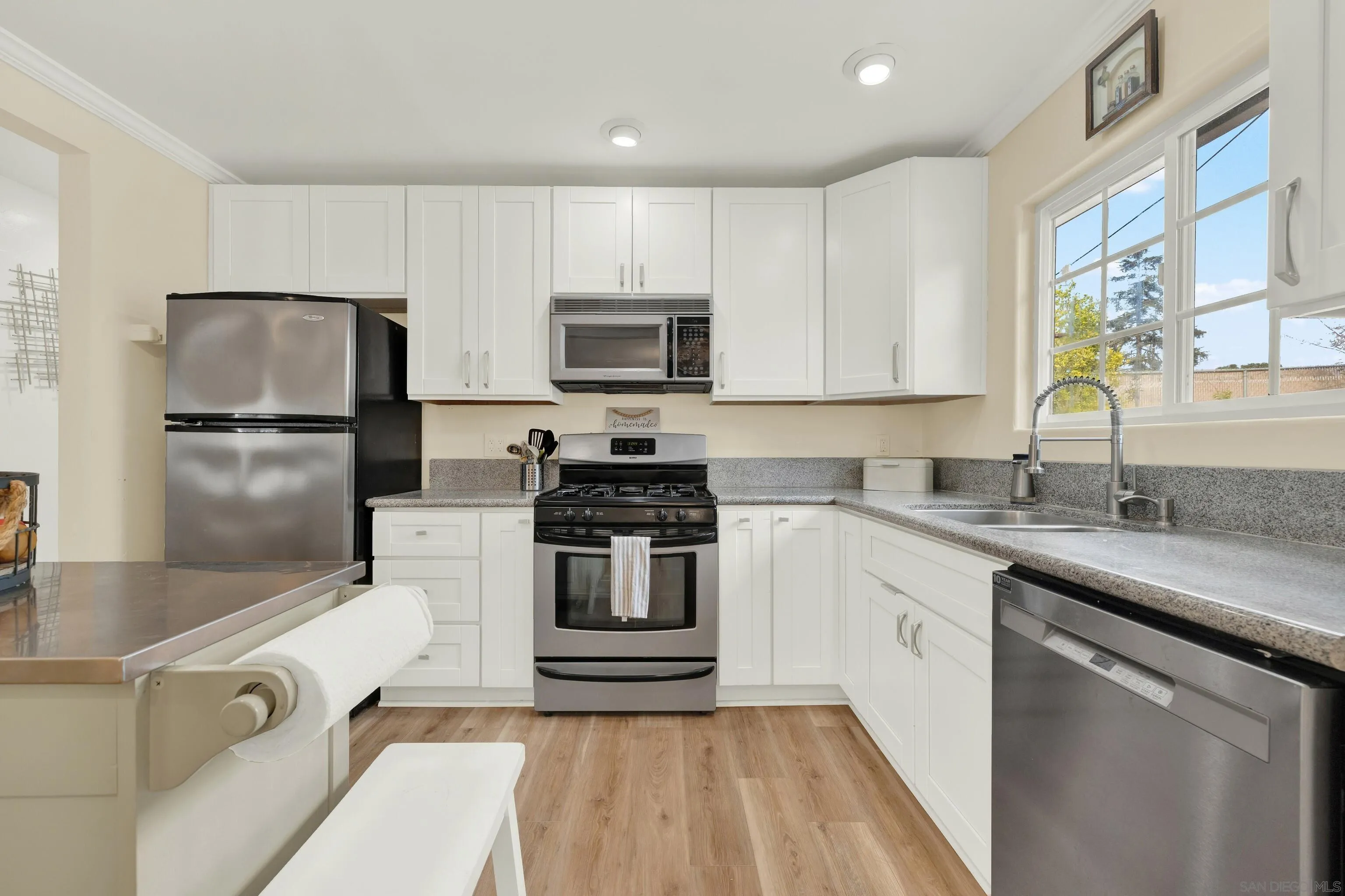 9515 Domer Road Santee, CA 92071 - Photo 18 of 45 a kitchen with kitchen island a sink stove and refrigerator
