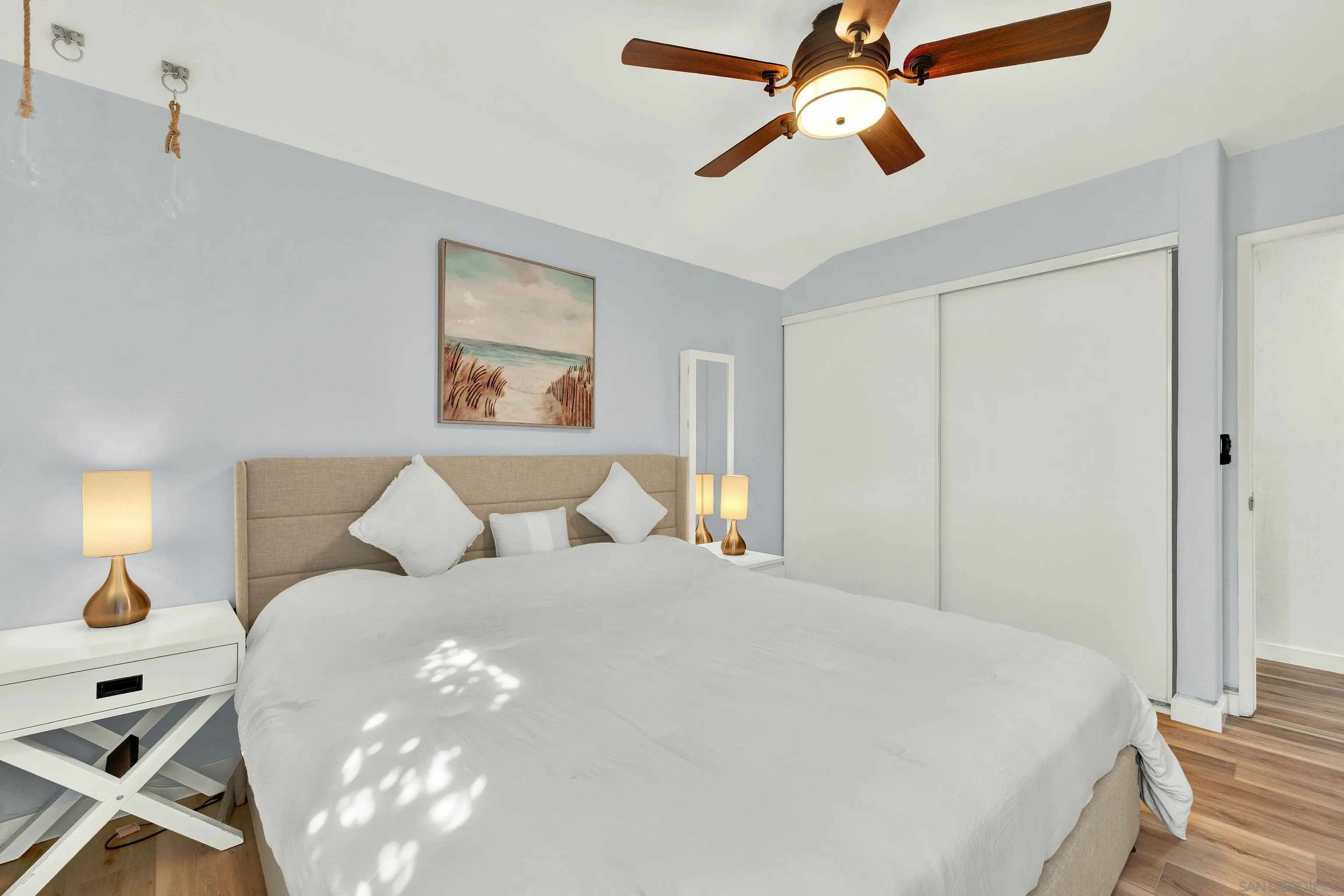 9515 Domer Road Santee, CA 92071 - Photo 31 of 45 a bedroom with a large bed and a chandelier