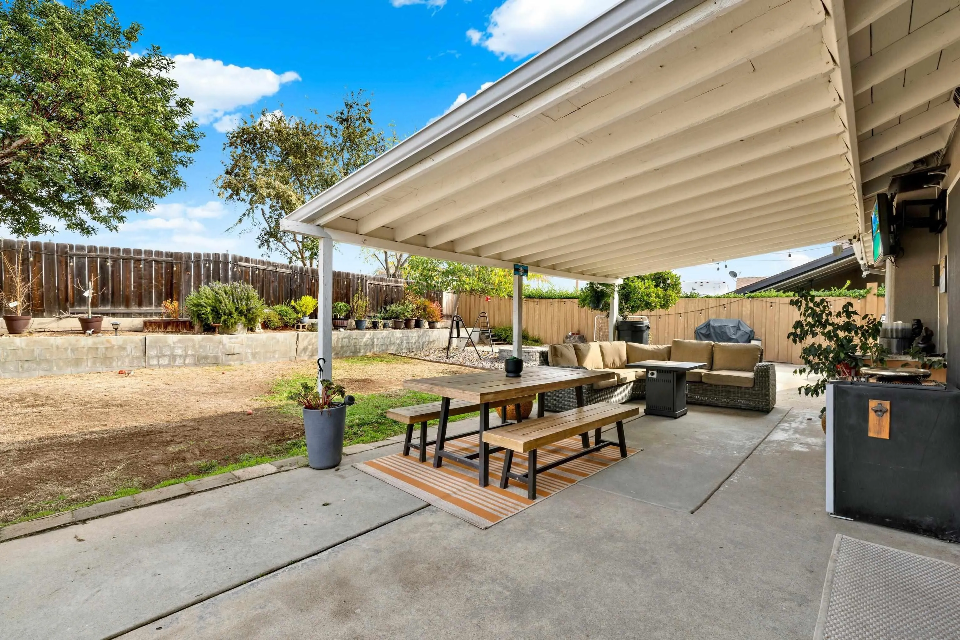 9515 Domer Road Santee, CA 92071 - Photo 36 of 45 a view of a patio with table and chairs under an umbrella with a barbeque
