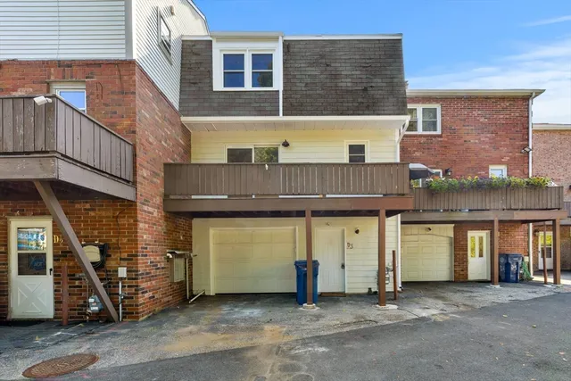 a view of a brick house with many windows