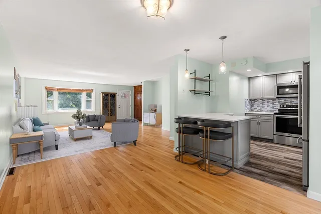 a living room with furniture and kitchen view