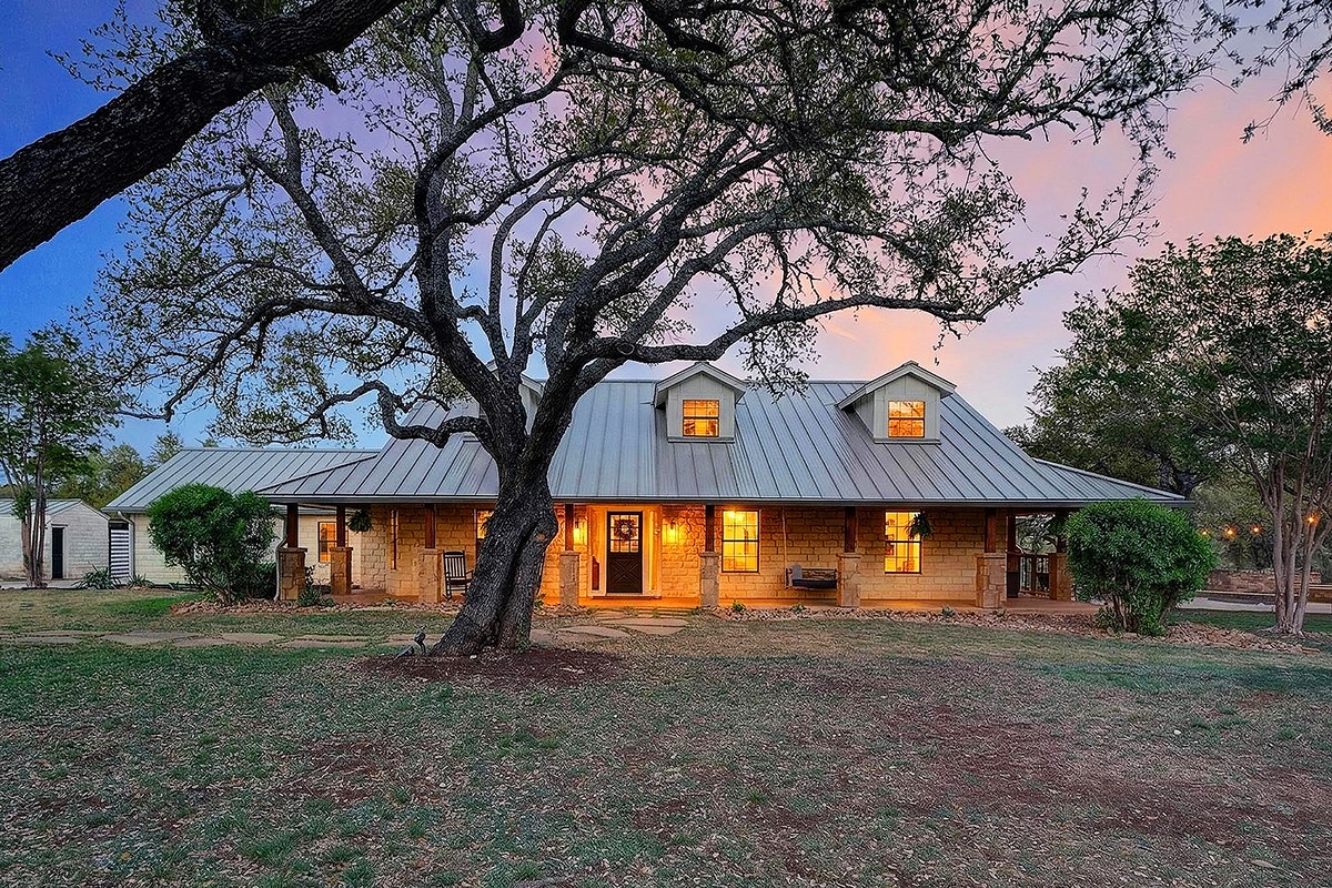 301 Medlin Creek Loop Dripping Springs, TX 78620 - Photo 2 of 40 View of front of house featuring a standing seam roof, a porch, and a front yard