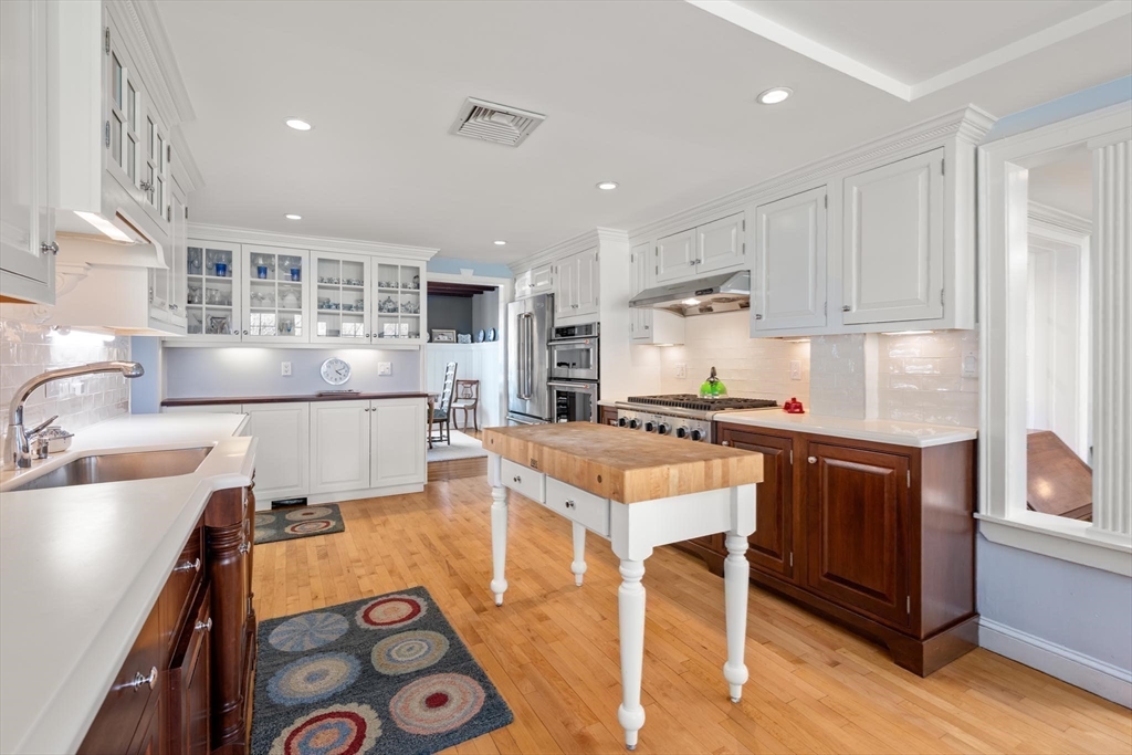 286 Quinobequin Road Newton, MA 02468 - Photo 9 of 31 a kitchen with a sink stove and cabinets