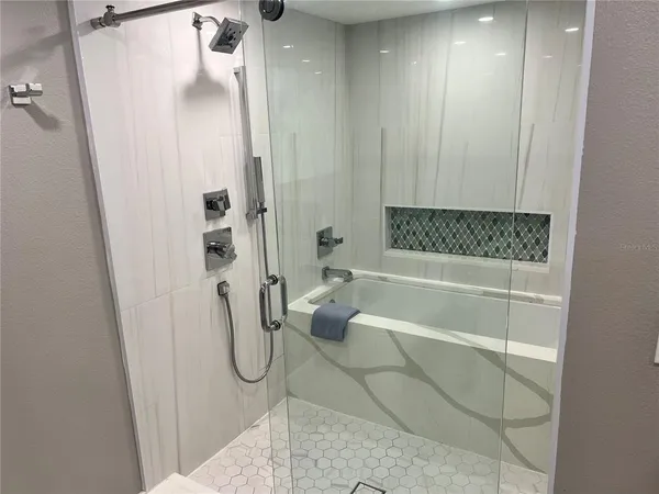 a bathroom with a glass shower door