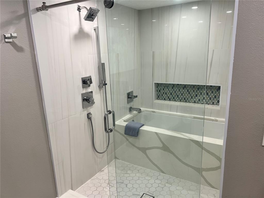 1001 Point Of Rocks Road, Unit 208 Sarasota, FL 34242 - Photo 11 of 33 a bathroom with a glass shower door