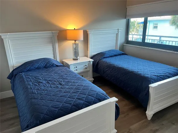 a bedroom with bed and window