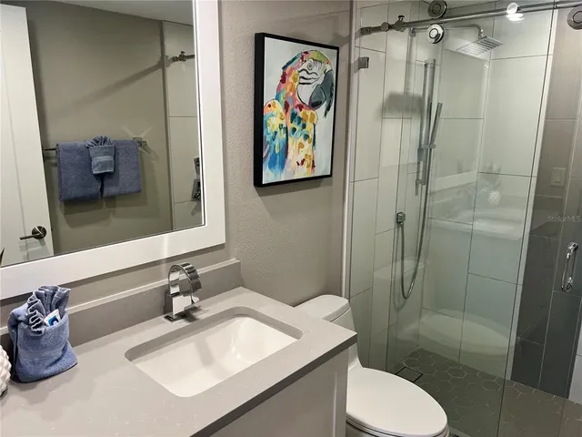 a bathroom with a toilet sink and shower