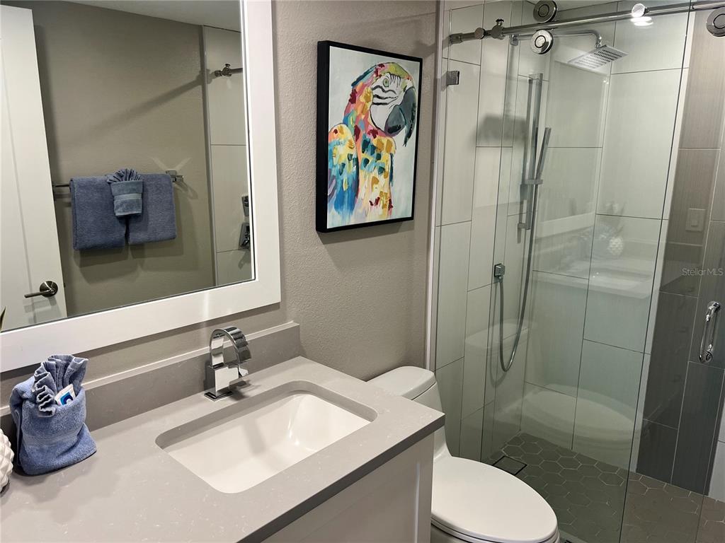 1001 Point Of Rocks Road, Unit 208 Sarasota, FL 34242 - Photo 14 of 33 a bathroom with a toilet sink and shower