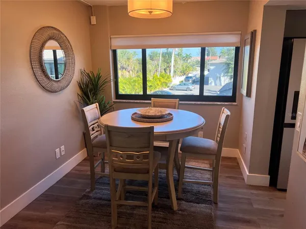 a dining room with furniture and a window