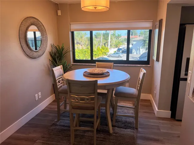 a dining room with furniture and a window