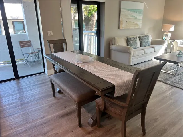 a view of a dining room with furniture and wooden floor