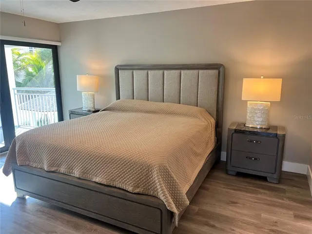 a large bed sitting in a bedroom next to a window