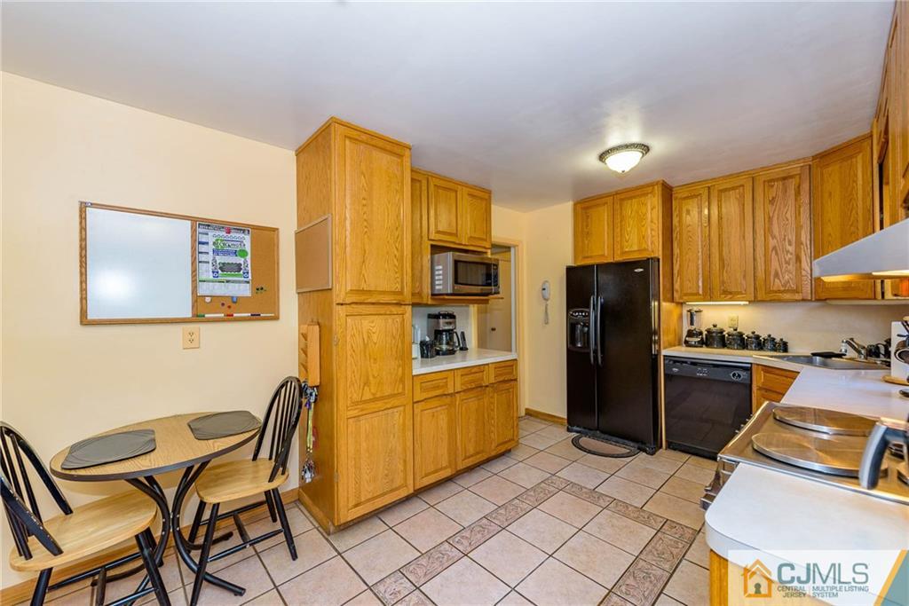 14 Gifford Road Somerset, NJ 08873 - Photo 12 of 25 a kitchen with stainless steel appliances granite countertop a refrigerator and a stove top oven