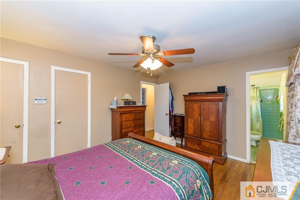 14 Gifford Road Somerset, NJ 08873 - Photo 17 of 25 a bedroom with a bed and a chandelier