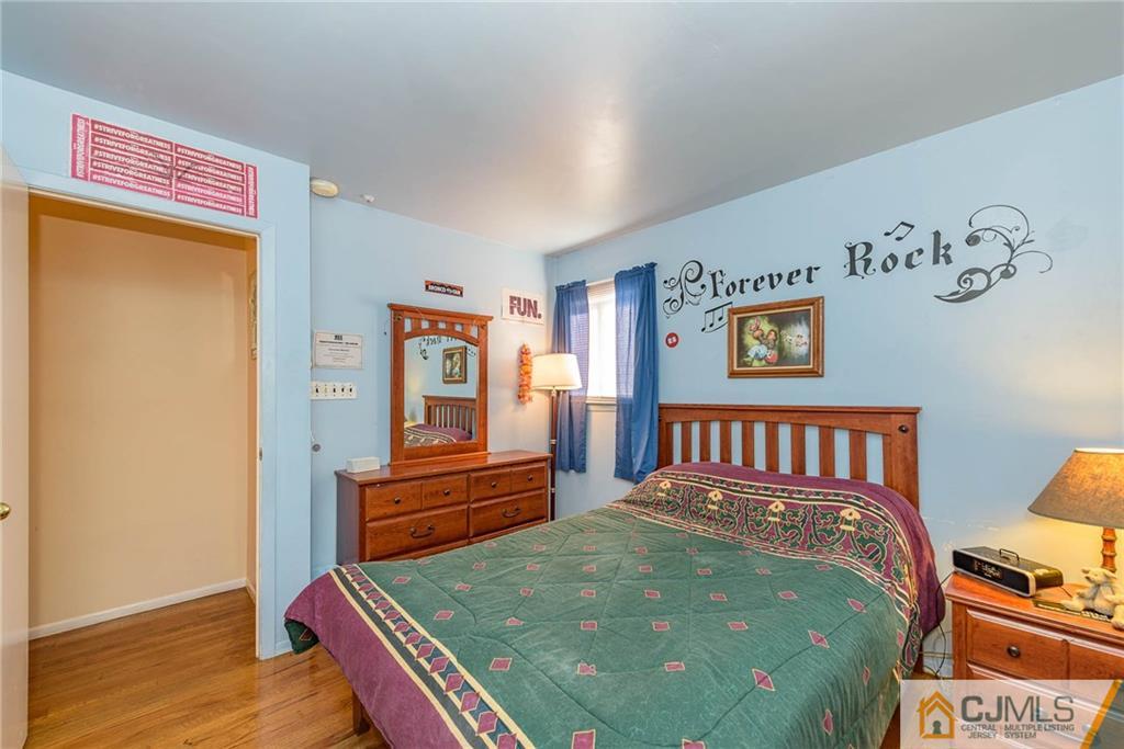 14 Gifford Road Somerset, NJ 08873 - Photo 18 of 25 a bedroom with a bed and wooden floor