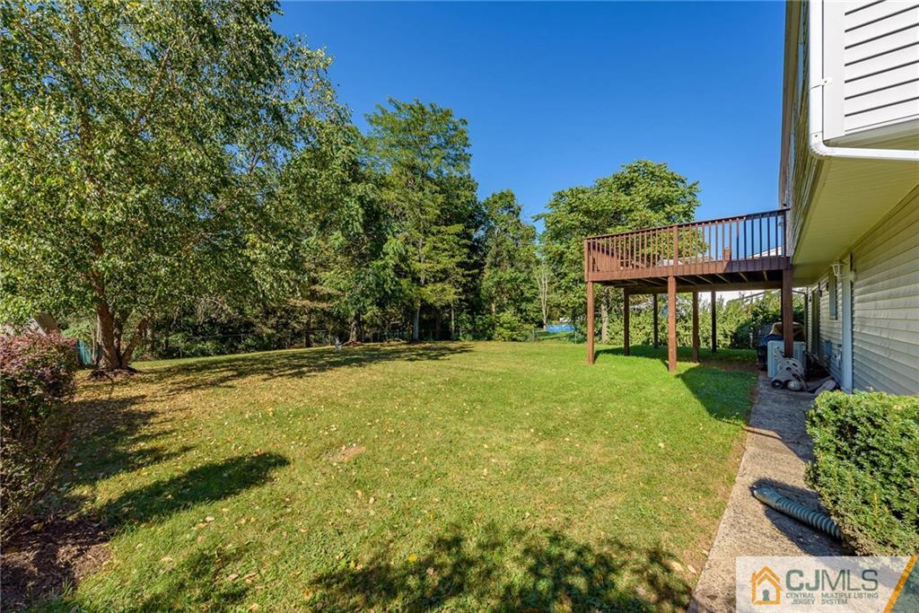 14 Gifford Road Somerset, NJ 08873 - Photo 23 of 25 a view of a swimming pool with lawn chairs under an umbrella