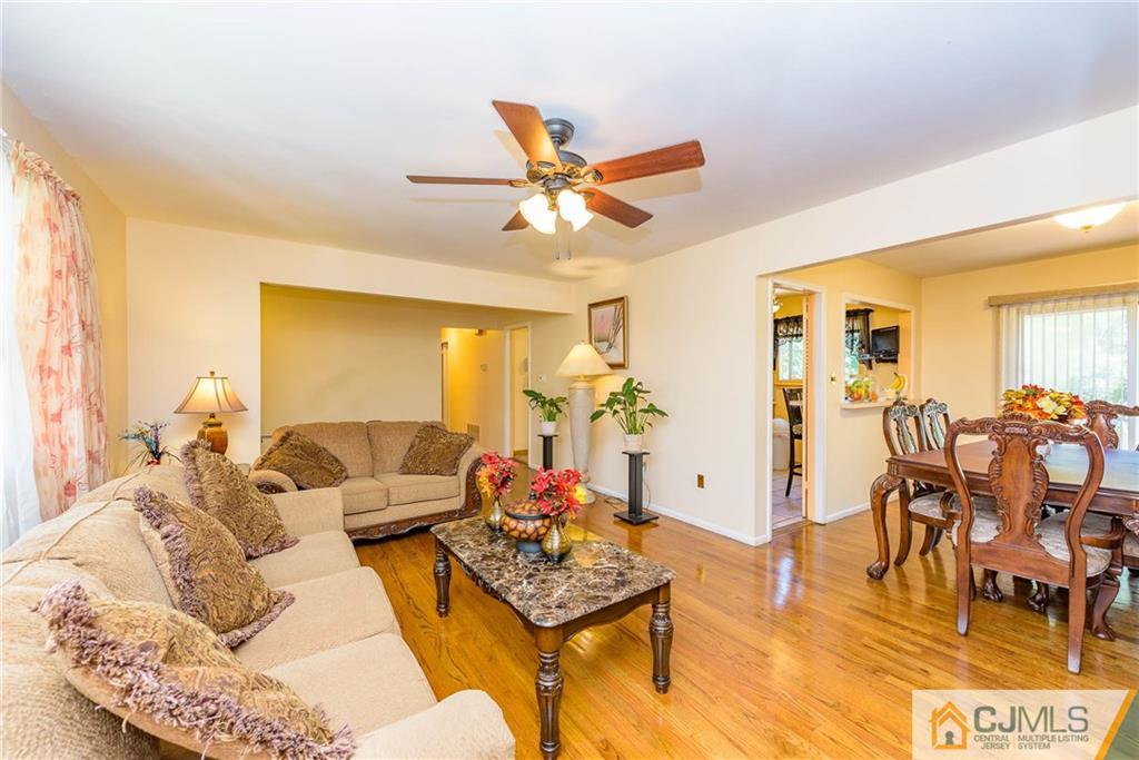 14 Gifford Road Somerset, NJ 08873 - Photo 8 of 25 a living room with furniture a chandelier and a dining table