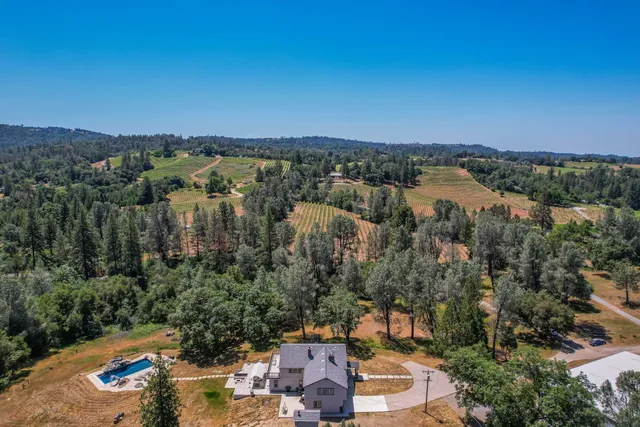 an aerial view of a house with a yard