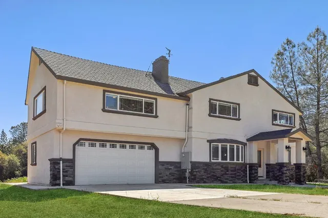 a front view of a house with garden