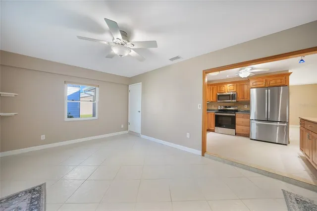 a kitchen with granite countertop a refrigerator oven a sink and dishwasher