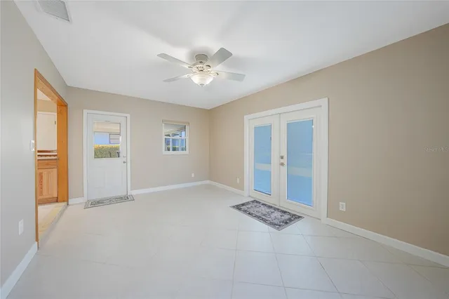 an empty room with windows and closet
