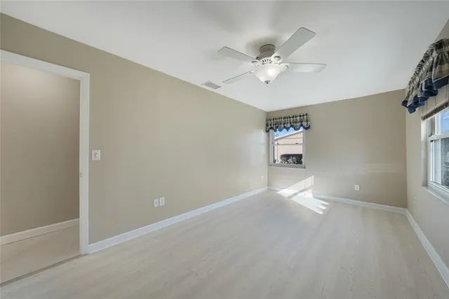 a view of a livingroom with a ceiling fan and window