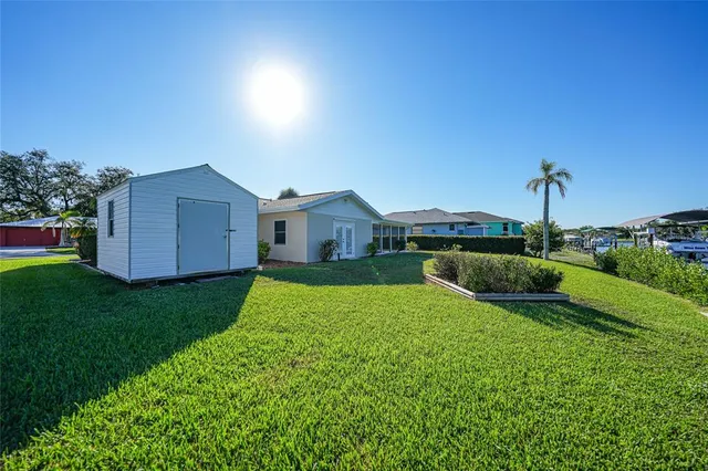 a view of a house with a yard and a garden