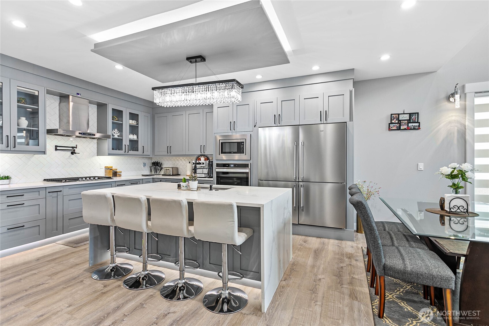 2144 Riverstone Loop Ferndale, WA 98248 - Photo 12 of 36 a kitchen with a table chairs refrigerator and microwave