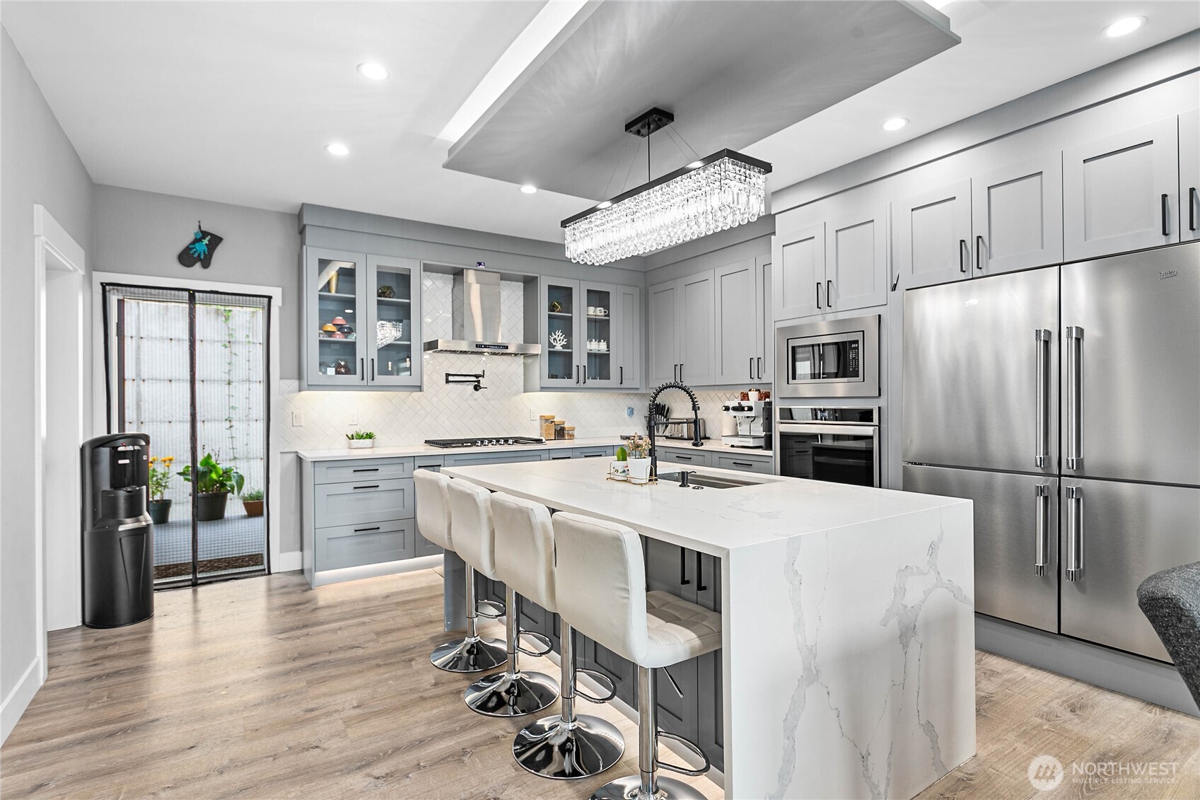 2144 Riverstone Loop Ferndale, WA 98248 - Photo 13 of 36 a kitchen with stainless steel appliances a dining table chairs refrigerator and cabinets