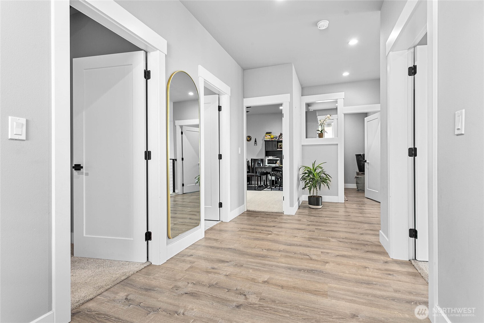 2144 Riverstone Loop Ferndale, WA 98248 - Photo 21 of 36 a view of a hallway with wooden floor and a living room