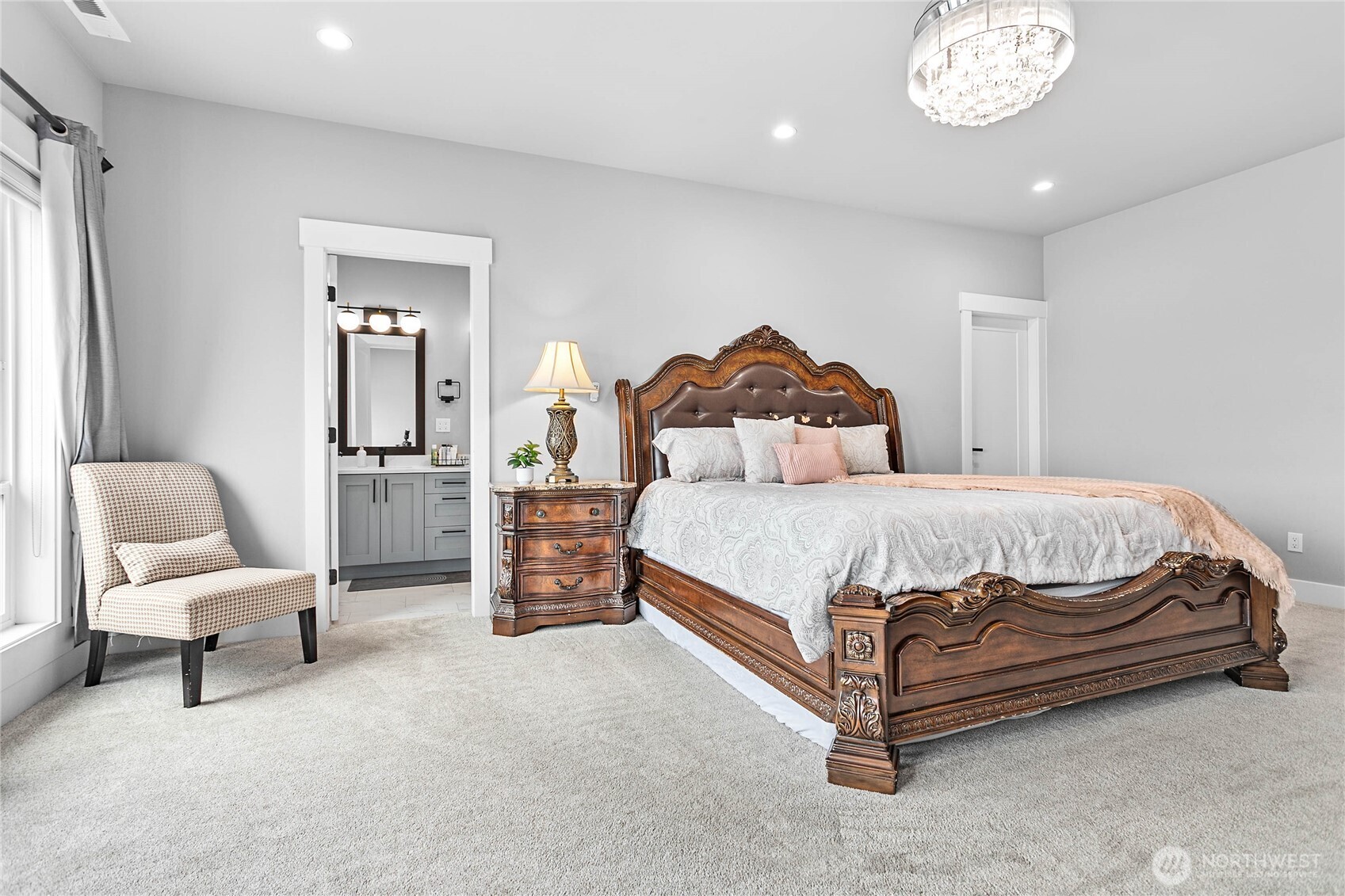 2144 Riverstone Loop Ferndale, WA 98248 - Photo 23 of 36 a bedroom with a bed and a chandelier