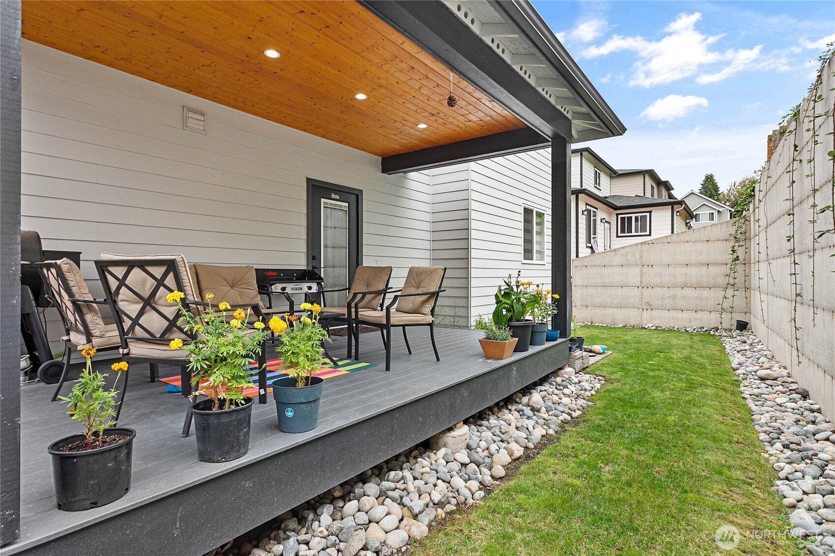 2144 Riverstone Loop Ferndale, WA 98248 - Photo 34 of 36 a view of a patio with table and chairs potted plants with wooden fence