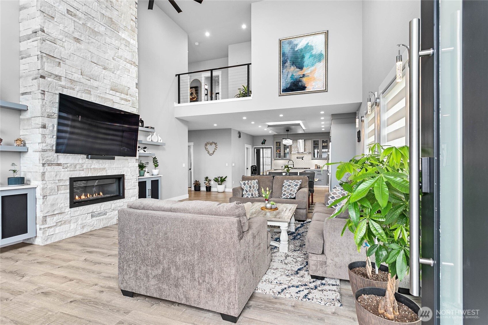 2144 Riverstone Loop Ferndale, WA 98248 - Photo 4 of 36 a living room with furniture a fireplace and a flat screen tv