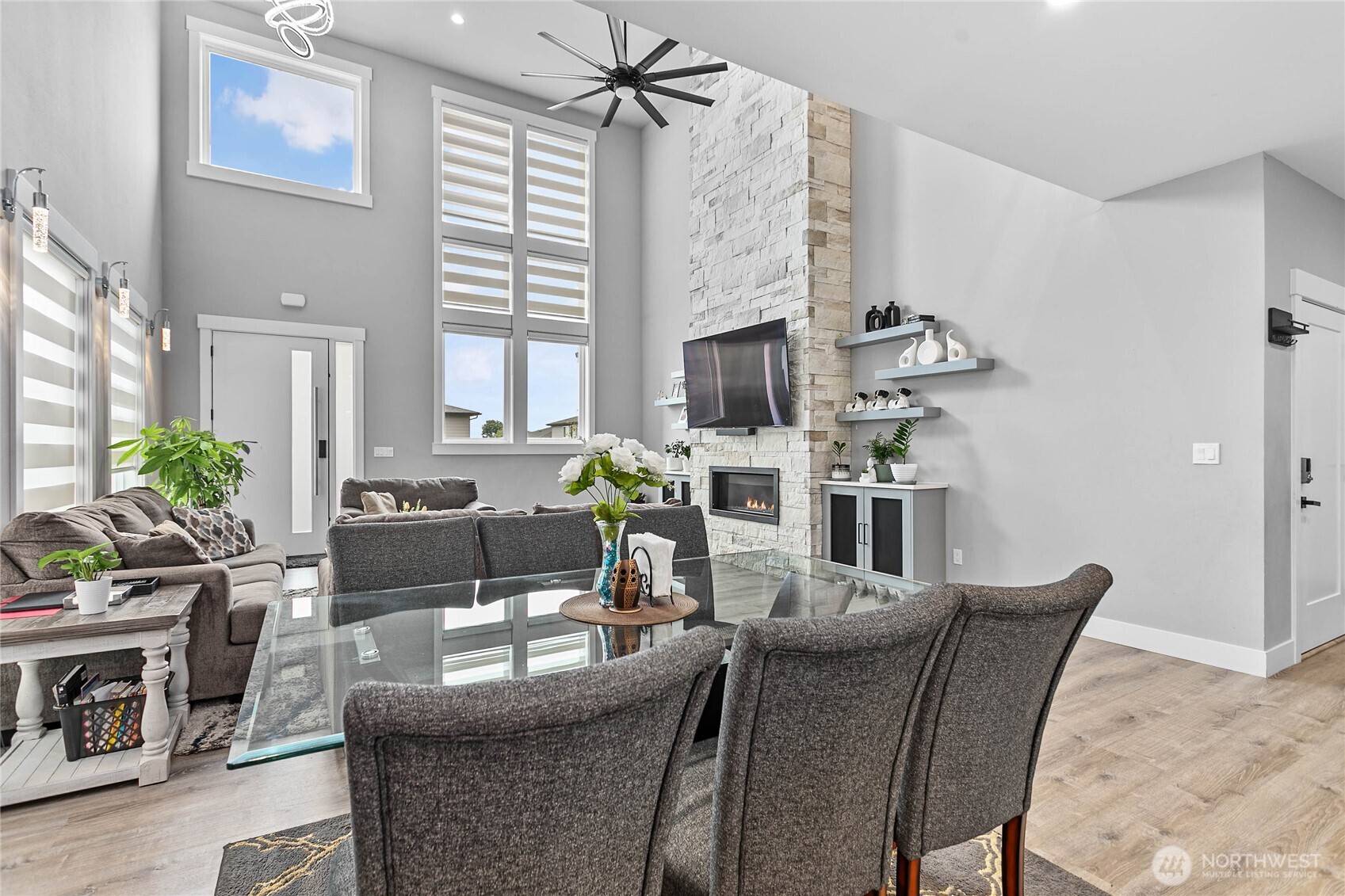 2144 Riverstone Loop Ferndale, WA 98248 - Photo 8 of 36 a dining room with furniture a chandelier and a fireplace