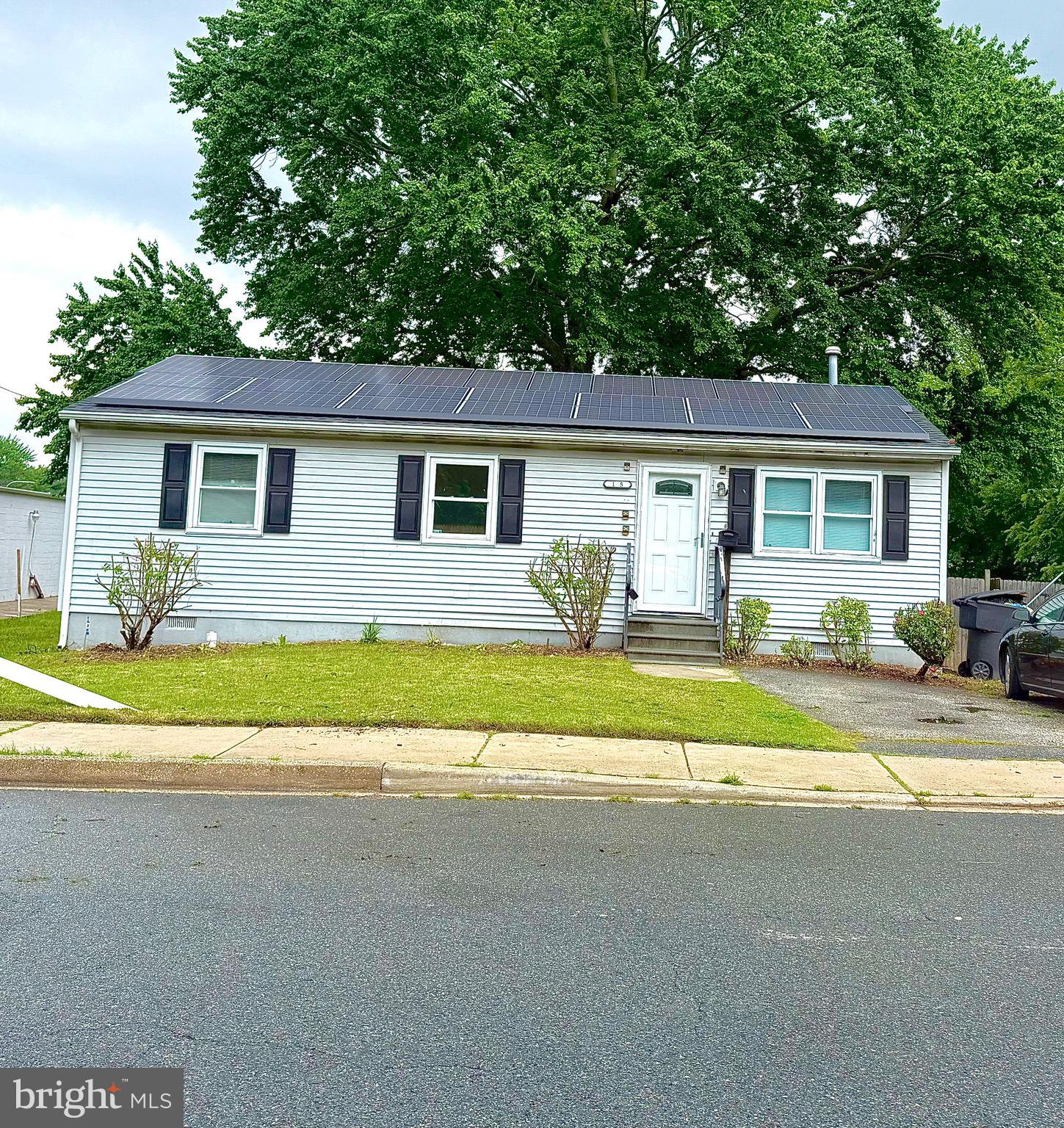a front view of a house with a yard and a garage