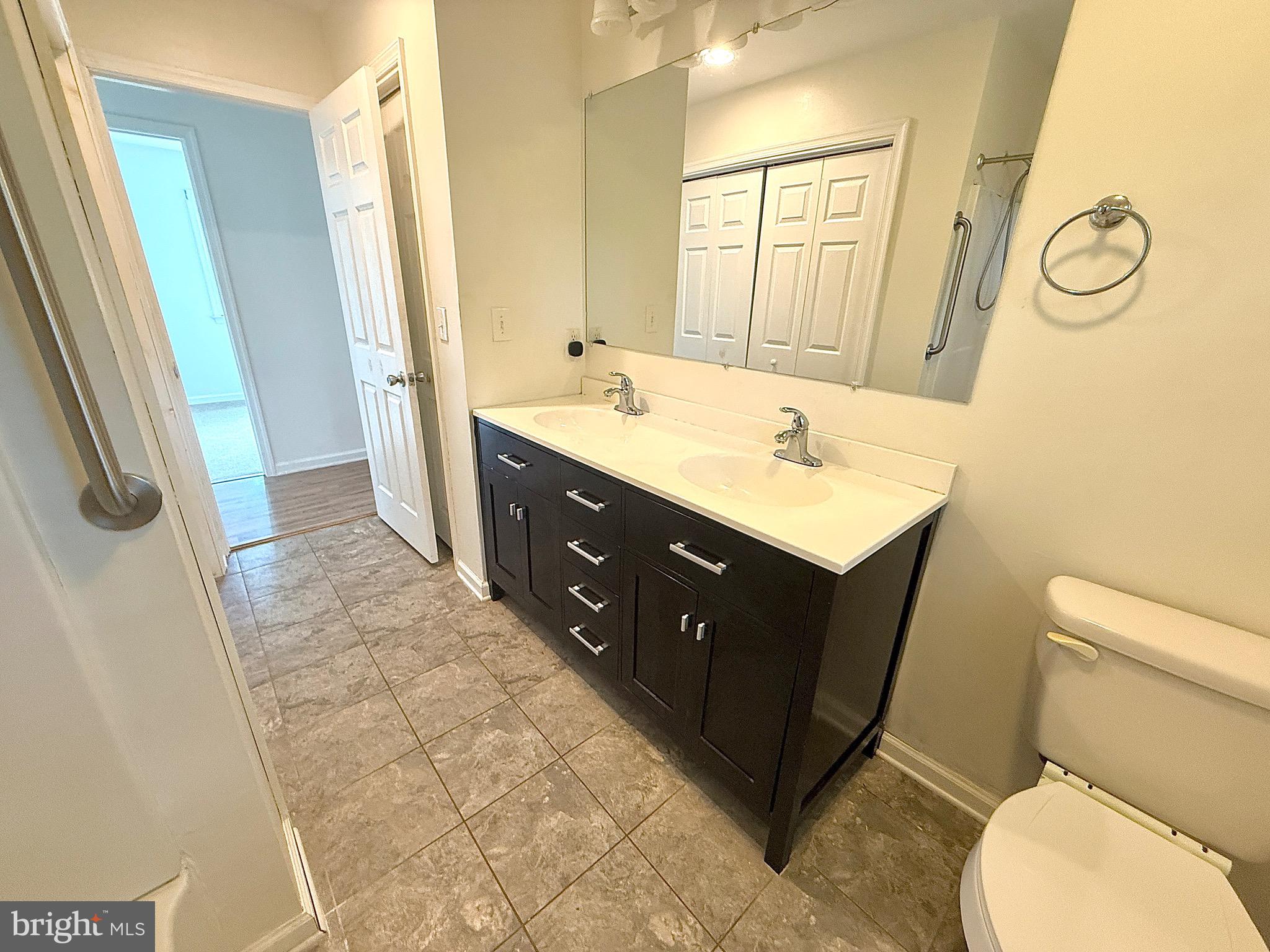 195 Mitscher Road Dover, DE 19901 - Photo 11 of 24 a bathroom with a sink vanity granite toilet and a mirror