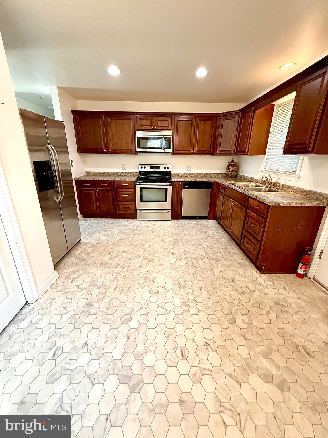195 Mitscher Road Dover, DE 19901 - Photo 5 of 24 a large kitchen with stainless steel appliances kitchen island granite countertop a sink and cabinets