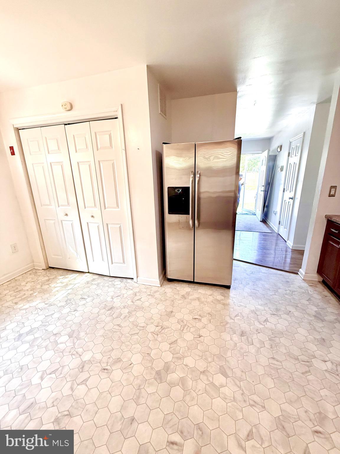 195 Mitscher Road Dover, DE 19901 - Photo 6 of 24 a view of a refrigerator in kitchen and wooden floor
