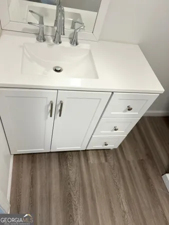 a white toilet sitting next to a white wall