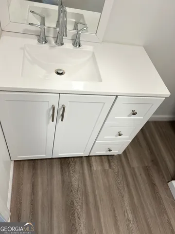 a white toilet sitting next to a white wall